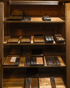 Display of cigars in a humidor at a vape and smoke shop.