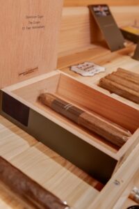 Close up shot of cigars on a shelf in a humidor.